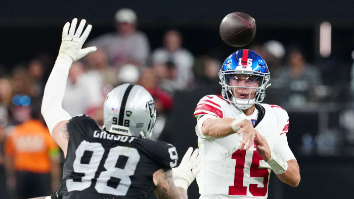 Nov 5, 2023; Paradise, Nevada, USA; New York Giants quarterback Tommy DeVito (15) is pressured by Las Vegas Raiders defensive end Maxx Crosby (98) during the fourth quarter at Allegiant Stadium.